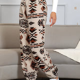 Women's fleece joggers featuring an Aztec pattern in a cozy, ethnic print design, showcasing vibrant colors like orange on a textile material.