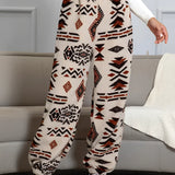 Aztec Pattern Fleece Joggers in orange and white ethnic print, designed for women, displayed in size XL. The pants feature a comfortable and cozy fleece material with an elastic waistband and tapered legs, ideal for active or casual wear.