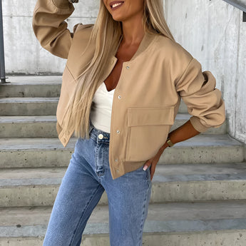 Beige cropped puffer jacket for women, displayed on a model wearing jeans, showcasing casual fashion outerwear with a focus on the shoulder and neck areas.