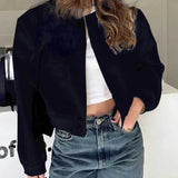 Dark blue cropped puffer jacket for women, styled with casual fashion in mind; features include a high neck and long sleeves, paired with jeans for a trendy look.