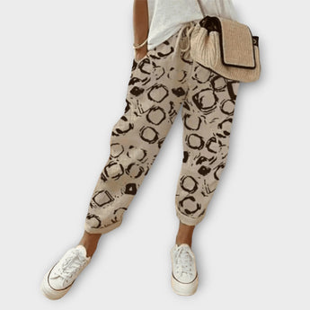 Beige snakeskin leggings featuring a trendy circle pattern in size 3XL, designed for women's fashion with a focus on style and comfort.