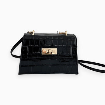 Black crocodile embossed handbag with a luxurious gold buckle, featuring a rectangular shape and crossbody design, perfect for fashion-forward events.