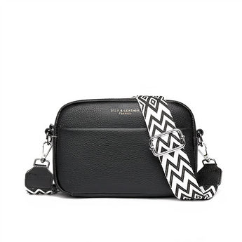 Black leather crossbody bag with a designer geometric strap, featuring a sleek rectangular shape and stylish pattern detailing, labeled as "Nero".