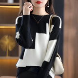 Black and white geometric patterned crewneck sweater for women, showcasing long sleeves and a chic, modern design.