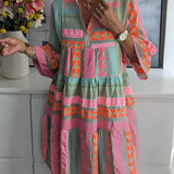 Bohemian patterned tiered midi dress in pastel ethnic print featuring floral designs, a fitted waist, and long sleeves, suitable for women's fashion.