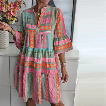 Bohemian patterned tiered midi dress in pastel ethnic print, featuring a multicolor design with tiered layers, long sleeves, and a comfortable fit.