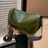 Boho leather handbag in green with artisan embroidery, featuring a crossbody strap and shoulder bag design.