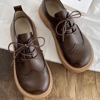 Brown leather wingtip brogues for men, handcrafted with intricate brogue detailing, shown in coffee color, size 40, designed as formal shoes.