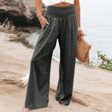 
A pair of women's flowy, wide-leg burgundy bohemian palazzo pants in a dark gray color, size 3XL, shown on a person standing outdoors.