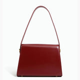 Burgundy leather handbag with a golden clasp, featuring a rectangular shape and elegant design, suitable as a stylish fashion accessory.