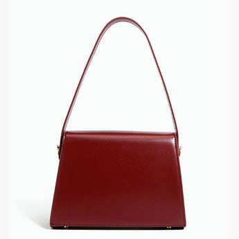 Burgundy leather handbag with a golden clasp, featuring a rectangular shape and elegant design, suitable as a stylish fashion accessory.