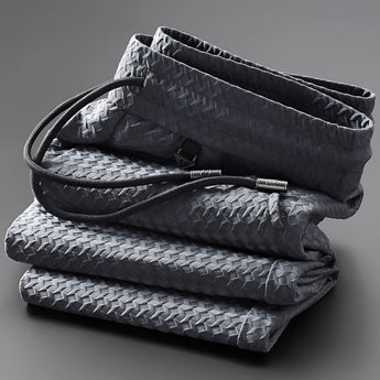 Gray braided leather handbag featuring a rectangular shape with woven texture, metal hardware, and an adjustable strap.