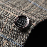 Herringbone wool tweed blazer in a tailored fit, designed for men's winter office wear, featuring a classic grey pattern with a structured collar and long sleeves.