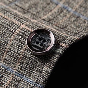 Herringbone wool tweed blazer in a tailored fit, designed for men's winter office wear, featuring a classic grey pattern with a structured collar and long sleeves.