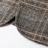 Herringbone wool tweed blazer in grey, tailored fit, featuring long sleeves and a distinctive woven pattern, suitable for men's winter office wear.