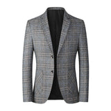 Men's tailored fit herringbone wool tweed blazer in gray, featuring a classic collar, button front, and long sleeves, suitable for winter office wear.