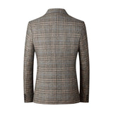 Men's grey herringbone wool tweed blazer with tailored fit, featuring long sleeves and a notched collar, suitable for winter office wear and formal occasions.