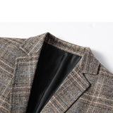 Men's tailored fit herringbone wool tweed blazer in grey, featuring a classic collar, long sleeves, and plaid pattern, ideal for winter office wear.