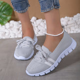 Lightweight breathable grey women's sneakers designed for comfort, ideal for walking, featuring a modern design with elements of white, blue, and black accents.