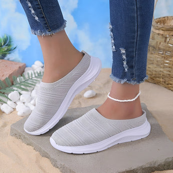 Lightweight women's breathable mesh slip-on sneakers in gray displayed against a plain background.