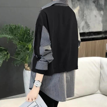 Modern asymmetrical black and white striped women's jacket with long sleeves, featuring a tailored fit around the waist and a chic, contemporary design.