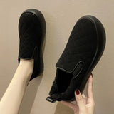 Quilted leather loafers for women, featuring faux fur lining, shown on a human foot. The shoes are grey, comfortable, and designed with synthetic rubber soles for winter wear.