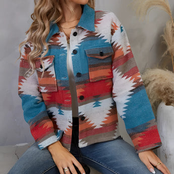 
A woman wearing a blue, XL Southwestern Aztec print denim jacket, styled in a boho fall fashion. She is accessorized with sunglasses and has open hair. The jacket's intricate Aztec design stands out, adding a fashionable touch to her outfit.