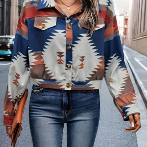 A woman wearing a Southwestern geometric patterned button-up jacket, styled for fall street fashion, paired with jeans and sunglasses. The jacket features long sleeves and a tartan-inspired design.