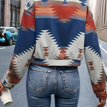 
A woman wearing a Southwestern geometric patterned button-up jacket styled for fall. The jacket features bold geometric designs and is paired with sunglasses, showcasing a chic street style. The model is standing, highlighting the shoulder, neck, sleeve, and waist details of the outerwear.