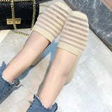 Women's casual denim shoes featuring a striped flat design and chained ankle detail, worn with jeans.