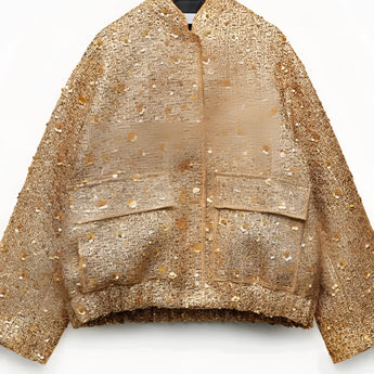 Textured gold metallic bomber jacket featuring long sleeves, a fur-trimmed collar, and displayed on a clothes hanger.