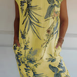 Tropical White Botanical Print Summer Shift Dress featuring a vibrant yellow floral design, displayed on a mannequin. The dress is a one-piece garment with short sleeves, a round neck, and a relaxed fit suitable for summer wear.