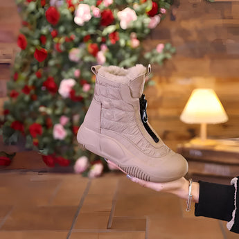 Women's waterproof quilted ankle boots with faux fur lining in cachi color, size 40, displayed indoors near a window with a wooden floor and a Christmas tree in the background.