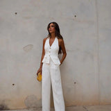 White backless jumpsuit for women, designed for formal and elegant evening wear, featuring a sleek and sophisticated fit.