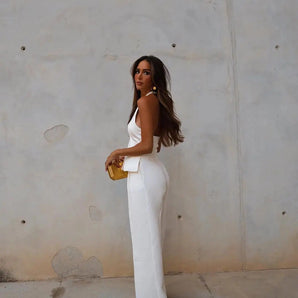 White backless jumpsuit for women, featuring a formal and elegant design suitable for evening wear, highlighting the waist and sleeveless structure.