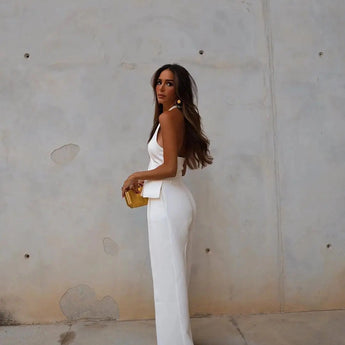 White backless jumpsuit for women, featuring a formal and elegant design suitable for evening wear, highlighting the waist and sleeveless structure.