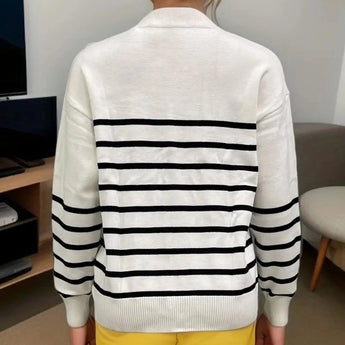 White and black monochrome striped women's crew neck knit sweater with long sleeves, showcasing a stylish and comfortable fashion piece.