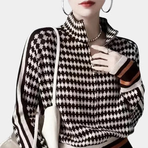 Black and white houndstooth patterned women's turtleneck sweater with long sleeves, showcasing a fitted design.