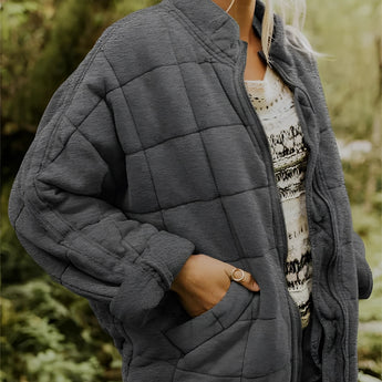 
A dark gray women's lightweight insulated quilted jacket in 2XL size, featuring a collar, long sleeves, and a fitted waist.