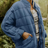 
A blue women's lightweight insulated quilted jacket in size 2XL, featuring a collar, long sleeves, and a waist-length design.