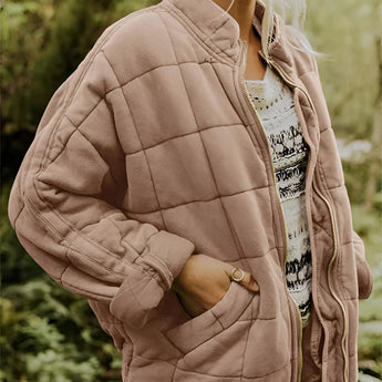 
A women's lightweight insulated forest green quilted jacket in khaki color, displayed in size 2XL. The jacket features a quilted pattern with a focus on outerwear elements such as a high neckline, long sleeves, and a fitted waist. It is made from natural materials and designed for comfort and style.