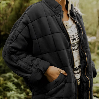 Women's lightweight insulated quilted jacket in a forest green color, featuring a sleek design with a collar and long sleeves. The jacket is displayed in a black color option, size 2XL, and has a quilted pattern that adds texture and style. The jacket is designed for comfort and warmth, suitable for cool weather.