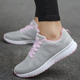 Women's lightweight sneakers in pink, designed for running, featuring a breathable mesh upper with a sleek and stylish appearance, suitable for casual wear and athletic activities.