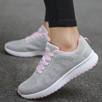 Women's lightweight sneakers in pink, designed for running, featuring a breathable mesh upper with a sleek and stylish appearance, suitable for casual wear and athletic activities.