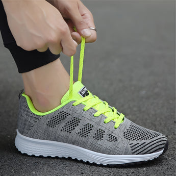 Women's lightweight pink and grey breathable running sneakers, designed for sports and outdoor activities.