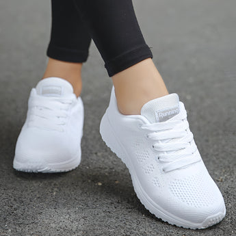 Women's pink lightweight sneakers designed for running, featuring breathable textile material and sportswear style.