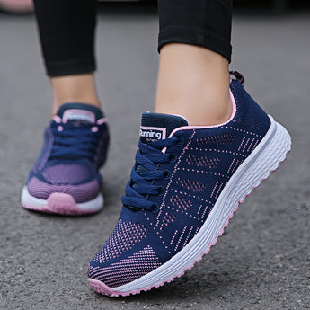 Women's lightweight sneakers in pink, featuring breathable textile material, suitable for running and walking. The shoe showcases a blend of purple and grey hues, with a design focused on comfort and support for various foot movements.